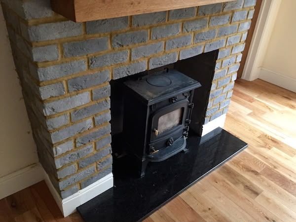 Bespoke timber fireplace surround with wood burning stove in Otley